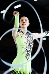 Image showing Gymnastics, dance performance and woman with ribbon for rhythmic movement, training and exercise. Aerobics practice, sports and female person in action for competition, workout and creative dancing