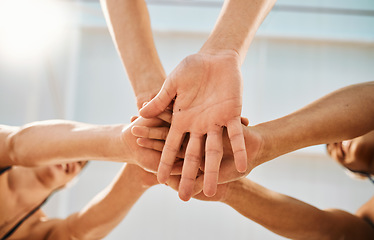 Image showing Hands stacked, sports and group of people for teamwork, collaboration and community fitness, team building and goals. Mission, workout and together sign of happy man and woman for exercise from below