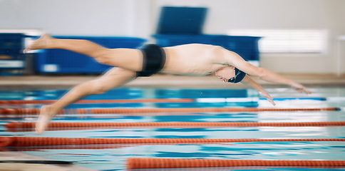 Image showing Sports, pool and male athlete diving for training, exercise or competition for indoor swimming. Fitness, action and young man swimmer doing a dive jump for a cardio workout or water sport gala.