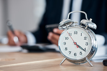 Image showing Business man, clock and time management in an office for deadline, punctual and busy schedule. Professional person or broker working at desk with an alarm, reminder and timer for goals and agenda