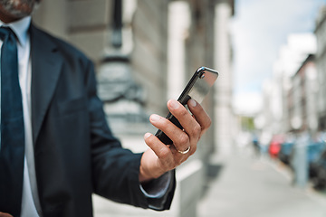 Image showing Hands, phone and travel with a business man in the city using an app for location, navigation or direction. Mobile, commute and communication with a male employee typing a message in an urban town