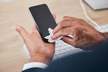 Image showing Closeup of man wipe his phone with a tissue to prevent germs, bacteria or dirt in his office. Technology, hands and male person cleaning cellphone screen for hygiene, health and wellness at workplace