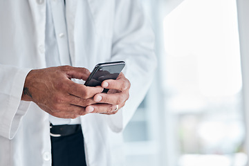 Image showing Phone, hands and doctor typing in hospital for research, telehealth and healthcare. Smartphone, medical professional and surgeon, expert or person on mobile app, wellness email or online consultation