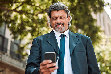 Image showing Senior businessman, phone and texting in street with smile, thinking and communication on internet. Mature entrepreneur man, smartphone and networking with web chat, social media and contact on app