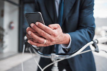 Image showing Phone, typing and hands of businessman with bicycle for travel, transport or directions to office, building or work in the city. Man, search and connection to internet with bike for journey in town