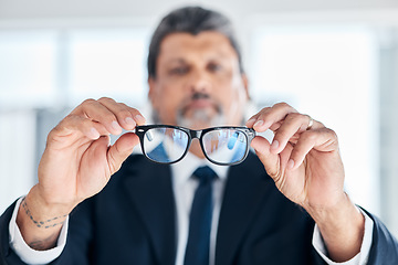 Image showing Man, hands and holding glasses at work for vision, bluelight security and cleaning lens. Closeup, bokeh and a mature corporate employee with eyewear for eyes support, frame and help with eye care