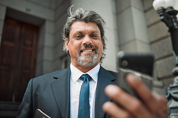 Image showing Happy man, social media or lawyer with phone for news, legal services update or networking online. Smile, mature advocate or senior judge typing on website to scroll, chat or search outside a court