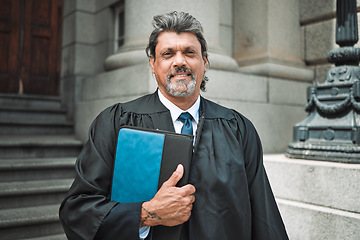 Image showing Portrait, book and a senior man judge at court, outdoor in the city during recess from a legal case or trial. Smile, authority and power with a confident magistrate in an urban town to practice law