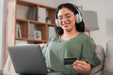 Image showing Woman, credit card and headphones for laptop online shopping, e learning and fintech payment on sofa. Student or person for music streaming subscribe, banking services and home education on computer