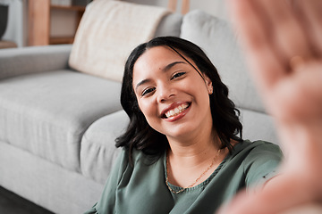 Image showing Selfie, happy and portrait of a woman in her living room relaxing, resting or chilling by the sofa. Happiness, smile and young female person from Mexico taking a picture at her modern home apartment.