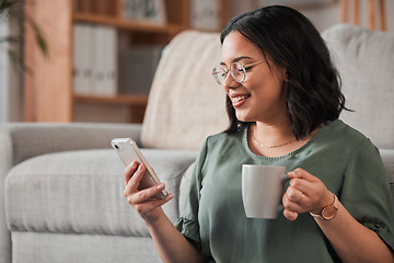 Image showing Woman, coffee and typing with phone in living room for social media post, reading notification or tech chat. Happy person, drinking tea and scroll on smartphone, download app and mobile games at home