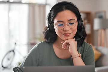 Image showing Woman, remote work and virtual assistant with headphones at laptop for video call, voip communication and telemarketing. Female consultant, computer and microphone for customer support at home office