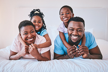 Image showing Smile, black family and portrait in a bed happy, care and comfort on the weekend in their home. Face, love and children with parents in bedroom playing, hug and relax while having fun together