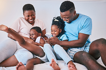 Image showing Laugh, black family and tickle in a bed with smile, care and happy on the weekend in their home. People, playing and children with parents in bedroom with games and having fun in the morning together