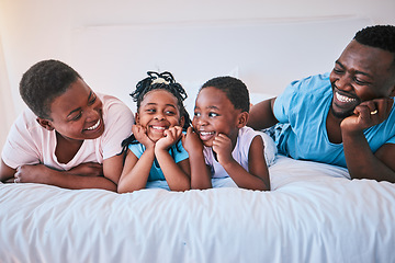 Image showing Smile, bond and black family in bed happy, talking and relax in their home on weekend. Love, face and children with parents in bedroom playful, free and chilling while enjoying conversation together