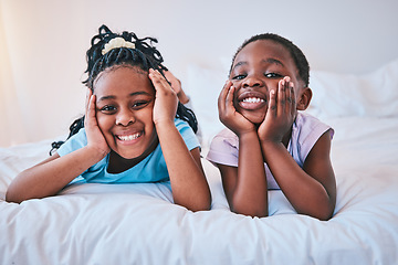 Image showing Happy, relax and portrait of children on the bed for playing, bonding and quality time in the morning. Cute, smile and little African kids or siblings in the bedroom of a house for childhood together