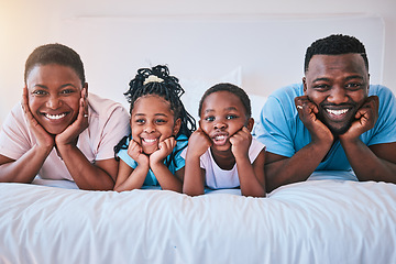 Image showing Smile, portrait and black family in bed happy, bond and relax in their home on the weekend. Love, face and children with parents in bedroom playful, free and chilling while enjoying morning together