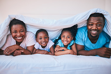 Image showing Happy, black family and portrait in a bed with blanket, relax and comfort on the weekend in their home. Face, smile and children with parents in bedroom playing, cover in the morning with fun