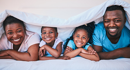 Image showing Smile, black family and portrait in a bed with blanket, relax and comfort on the weekend in their home. Happy, face and children with parents in bedroom playing, cover and rest, fun and cheerful