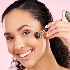 Image showing Facial roller, natural beauty and woman with skin glow, health or wellness cosmetics. Portrait of a young aesthetic female model happy with dermatology or stone massage results on a pink background