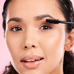 Image showing Mascara, beauty and makeup on face of a woman in studio for eyelash cosmetics and natural glow. Portrait, application and skin care tools or product on a female aesthetic model on a pink background