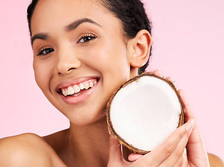 Image showing Woman face, coconut fruit and beauty, healthy skincare or vegan cream on pink studio background. Portrait of Mexican person in natural product for dermatology, eco friendly cosmetics and oil benefits