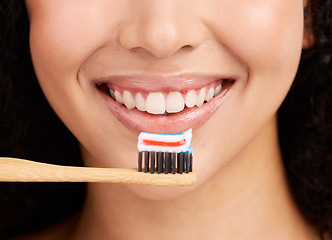 Image showing Smile, wood toothbrush and studio closeup for dental wellness, woman and healthy mouth by pink background. Girl, model and natural toothpaste for teeth whitening, results and sustainable product