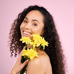 Image showing Skincare, face and beauty of woman with flowers in studio isolated on a pink background. Portrait, smile and natural model with plant, floral cosmetics or organic treatment for healthy skin aesthetic