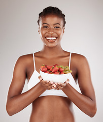 Image showing Healthy, portrait and black woman with fruit on a studio background for a diet to lose weight. Happy, wellness and an African model or girl with breakfast food, morning nutrition or eating for detox