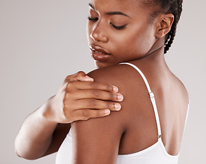 Image showing Black woman, shoulder pain and injury with health risk, muscle tension and stress on a grey studio background. Female person, inflammation or model with joint strain, sore and swollen with body ache