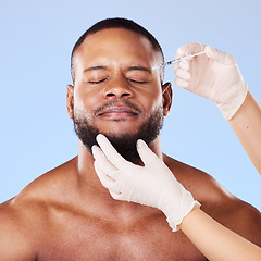 Image showing Needle, scared man and plastic surgery of skincare process, filler and aesthetic prp in studio. Face of black male model with fear, pain and anxiety for injection, facial change and blue background