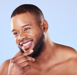 Image showing Black man, beard and comb in studio for beauty, aesthetic grooming and barber cosmetics. Face of male model, brush and facial hair care product, tool or accessory for routine, skincare and aesthetics