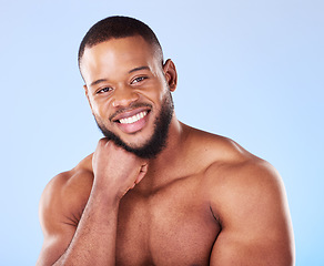 Image showing Cosmetics, portrait and black man with skincare, muscle and wellness against a blue studio background. Male person, model and guy with treatment, face and glow with dermatology, aesthetic and health