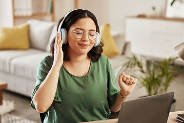 Image showing Laptop, music and streaming with a woman in her home, listening to the radio in the living room to relax. Computer, audio and headphones with a young female student in her house for education