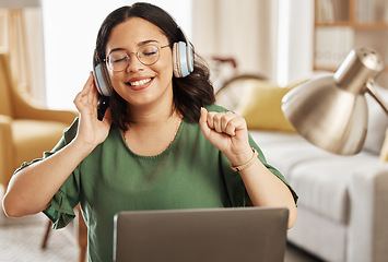 Image showing Laptop, music and headphones with a woman in her home, listening to the radio in the living room to relax. Computer, audio and streaming with a young female student in her house for education