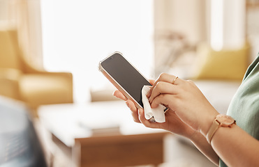 Image showing Screen, phone and closeup of cleaner with a tissue for cleaning germs, dirt or dust bacteria at home. Hygiene, technology and female person wipe cellphone to sanitize or disinfect in her living room.