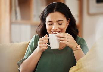 Image showing Coffee, relax and smile with a woman in her home, sitting on a sofa in the living room enjoying a beverage. Peace, quiet and eyes closed with a happy young female person drinking tea in her house