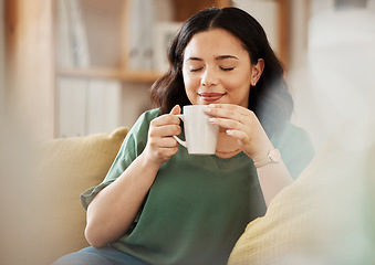 Image showing Tea, relax and smile with a woman in her home, sitting on a sofa in the living room enjoying a beverage. Peace, quiet and eyes closed with a happy young female person drinking coffee in her house