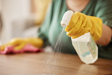 Image showing Hand, spray bottle and a woman cleaning a wooden surface in her home for hygiene or disinfection. Gloves, product and bacteria with a female cleaner using detergent to spring clean in an apartment