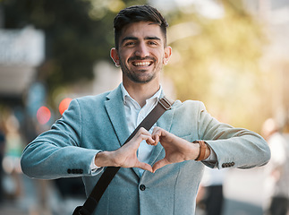 Image showing Hands in heart, business and portrait of man in city for support, startup goals and kindness in street. Travel, professional job and face of male worker with love emoji for career, working and job