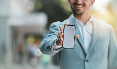 Image showing Hand, blank phone screen and space in street with happy business man for app mockup, promotion or branding. Smartphone, entrepreneur and smile for ux, iot logo or mobile web design on metro sidewalk