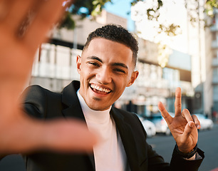 Image showing Selfie, peace sign and portrait of business man in city for social media, profile picture and post. Travel, professional and face of male worker with hand gesture excited for career, job and success