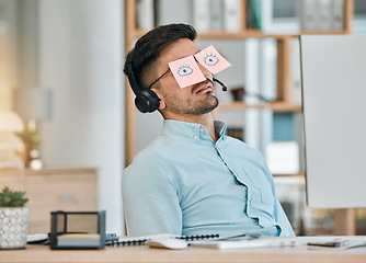 Image showing Tired, sleeping and business man with sticky note eyes from low energy and burnout at office desk. Fatigue, nap and rest of a male professional with drawing on glasses to pretend at a company