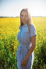 Image showing Beautiful woman in field with yellow flowers