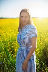 Image showing Beautiful woman in field with yellow flowers