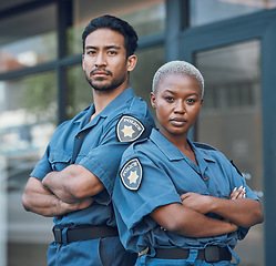 Image showing Portrait, serious and arms crossed with the police force standing outdoor in the city for law enforcement. Safety, security or surveillance with a man and woman officer on patrol in an urban town