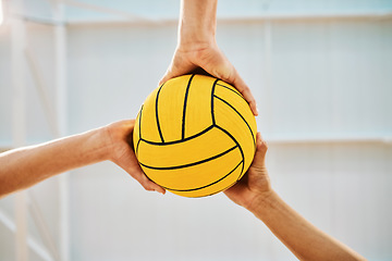 Image showing Hands, teamwork and water polo with sports people holding a ball in a gym for fitness or training from below. Exercise, game and solidarity with a group of athletes in a health center for a workout