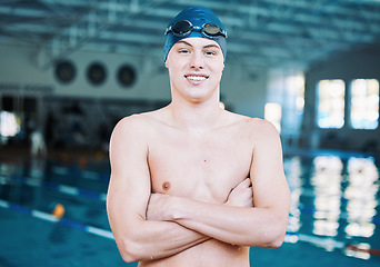 Image showing Swimming, sports and portrait of man by pool for training, competition and exercise in gym. Professional, fitness and male swimmer with crossed arms for challenge, workout and practice for wellness