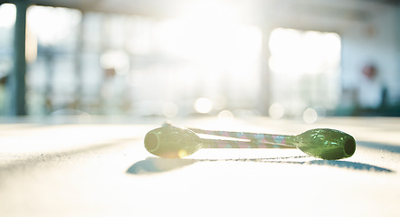 Image showing Fitness, dance and ribbon on the floor of a gym or studio for training with flare on a blurred background. Exercise, creative and equipment with a baton for dancing in an empty health center closeup