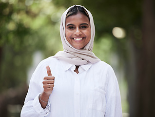 Image showing Thumbs up, happy and portrait of Muslim woman in park for support, agreement and yes outdoors. Happiness, smile and face of Islamic female person with hand sign for approval, thank you and success